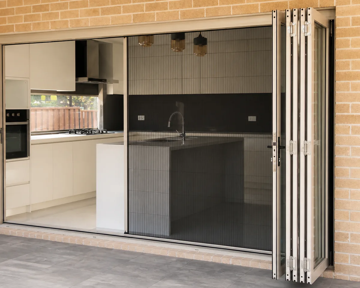 Retractable fly screen fitted across a wide opening