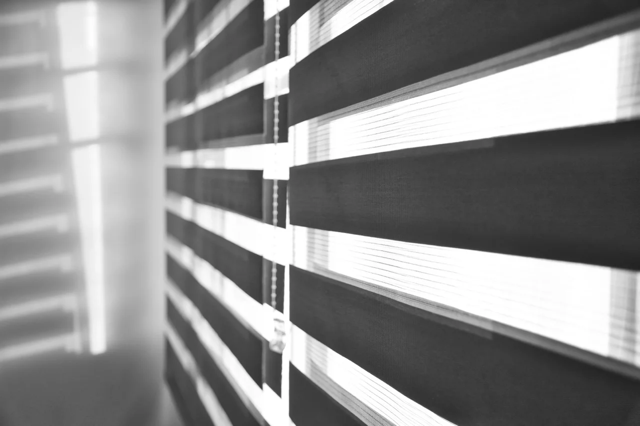 Zebra blinds filtering daylight across a window