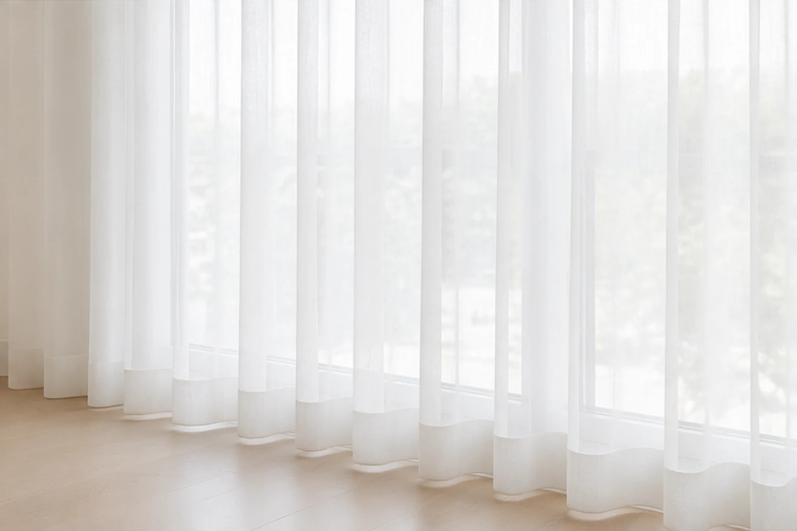 Sheer curtains across a bright window