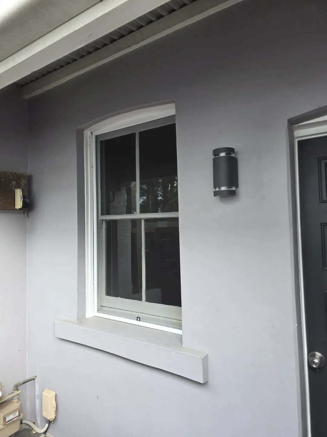 Fixed flyscreen fitted to a residential window with a clear city view.